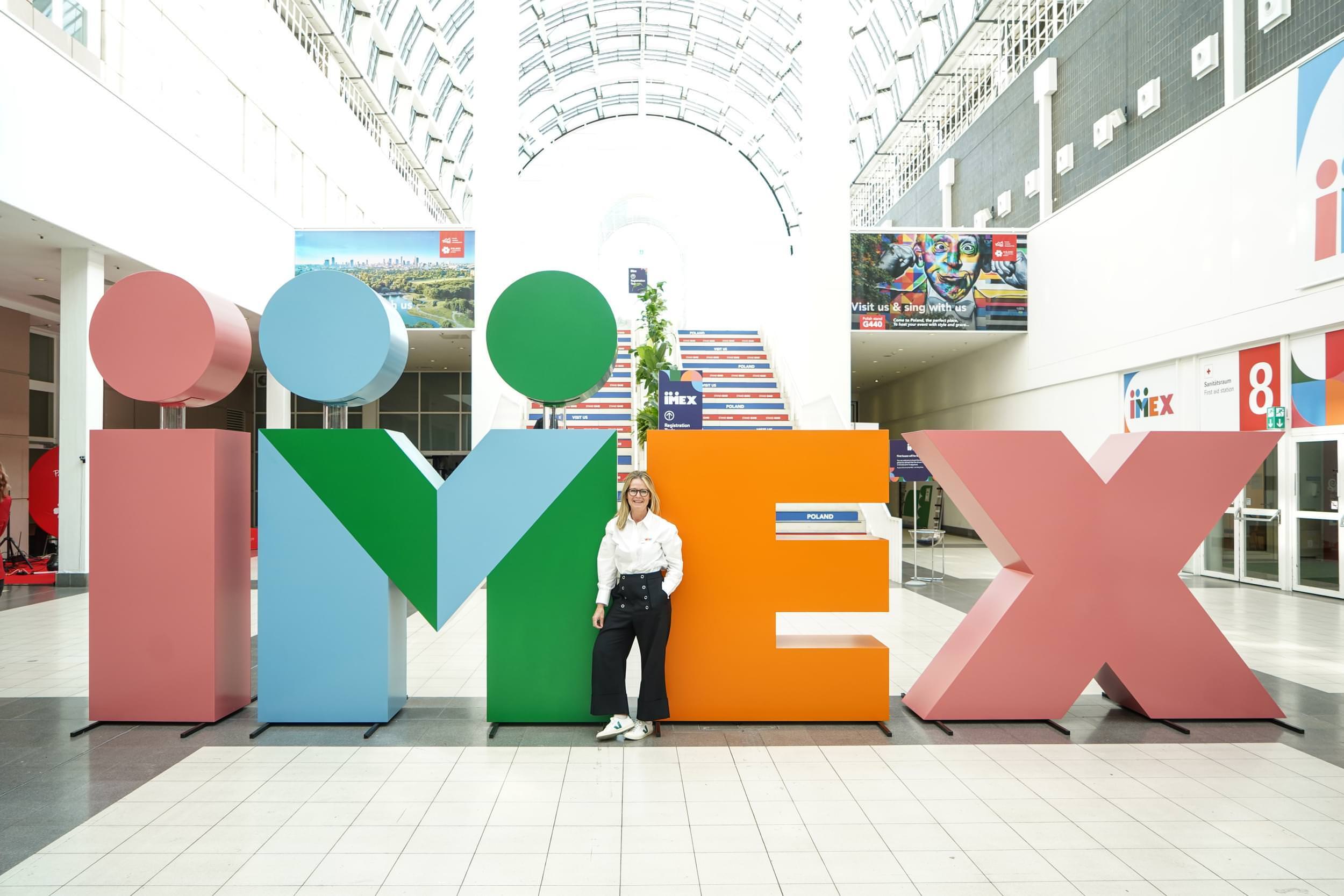 Design Manager Anna Gyseman unveils the new IMEX logo at IMEX Frankfurt