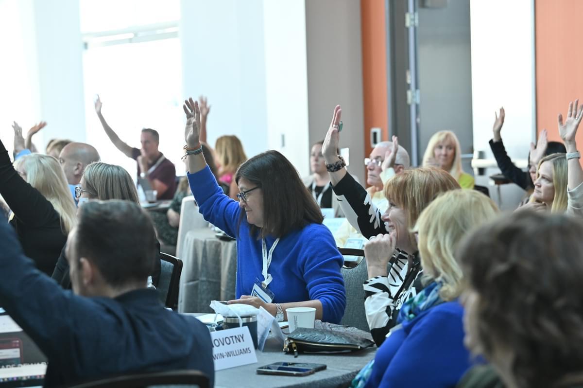 Raised hands at Executive meeting forum