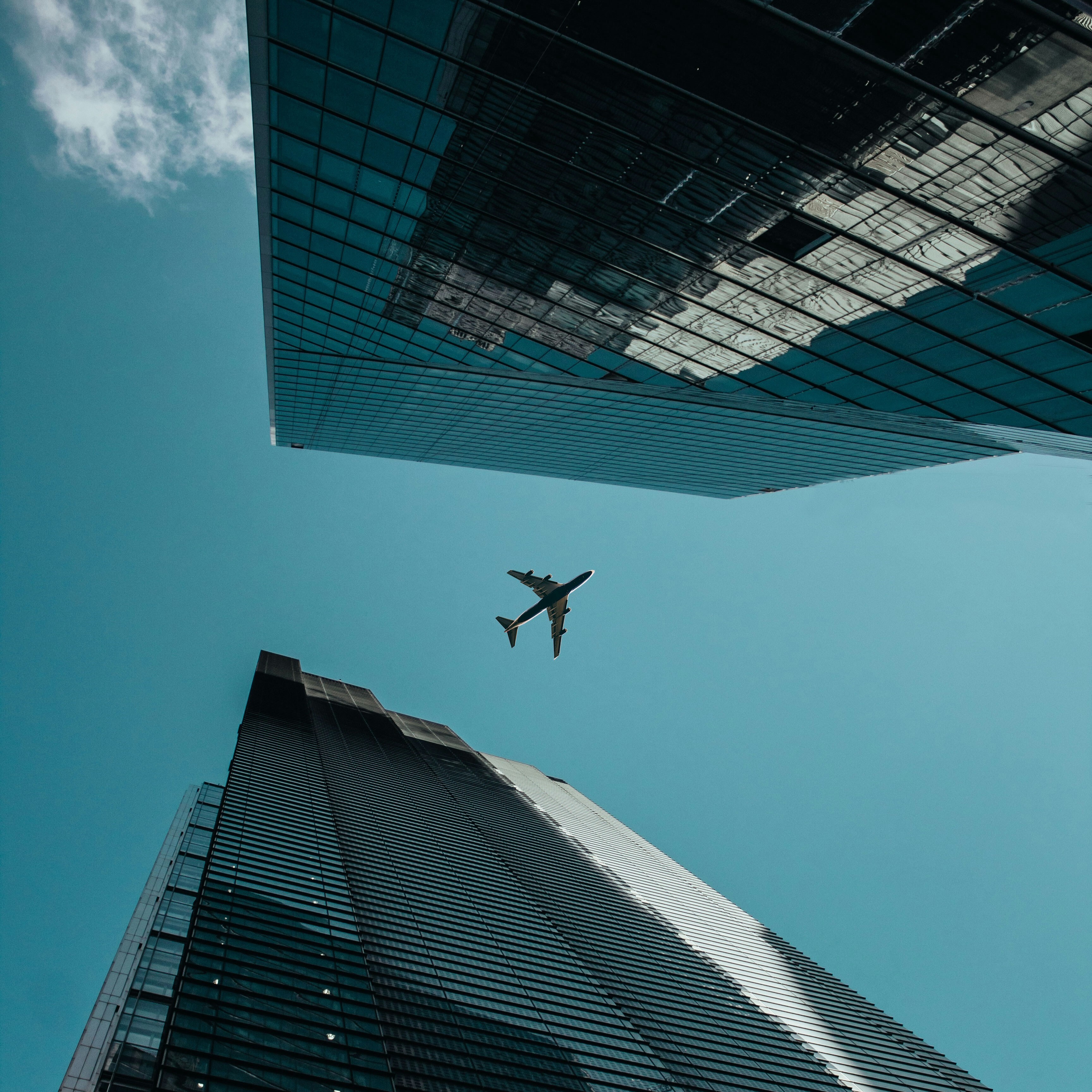 Plane flying over two skyscrapers