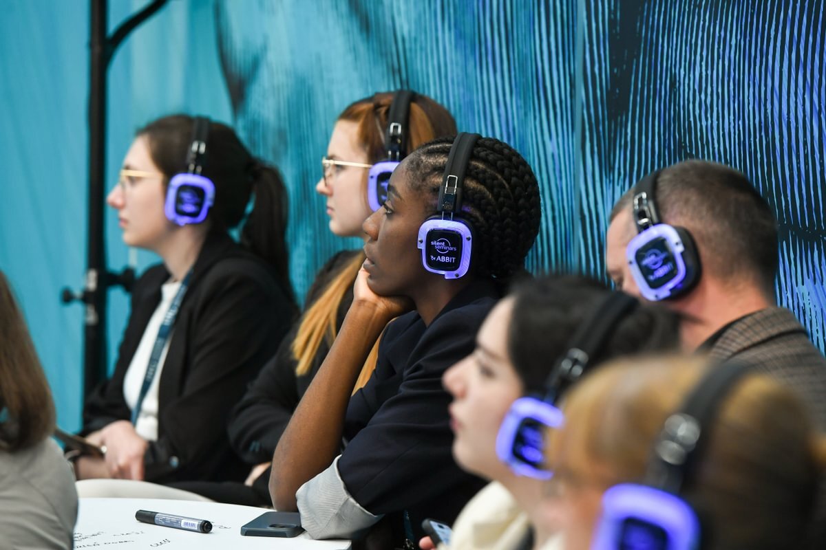 Attendees using Silent Seminar headphones at an education session