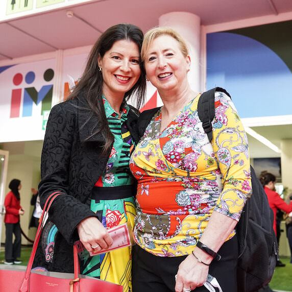 Two attendees smiling at IMEX Frankfurt
