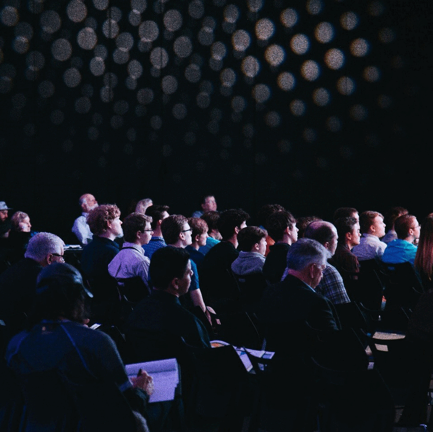 Audience at conference with low lighting