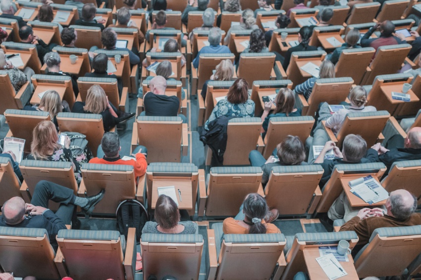 University lecture hall filled with students looking towards the front